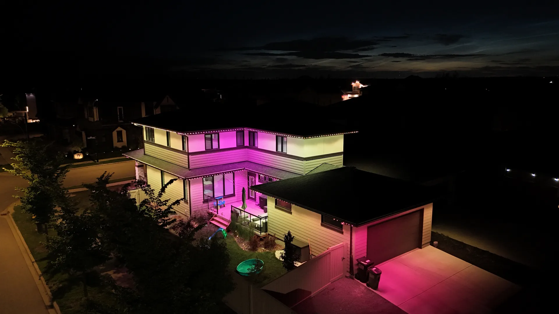 Permanent LED lighting showing pink and magenta colour options on an Edmonton home